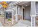 Close-up of the home's entrance with a Metro Brokers sign, showcasing the doorway and stone accents at 17271 Waterhouse Cir # A, Parker, CO 80134