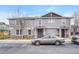 Exterior view of a well-maintained townhome with stone accents, featuring a car in the parking area at 17271 Waterhouse Cir # A, Parker, CO 80134