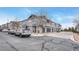 Wide exterior shot of a row of townhomes, each featuring a garage and stone detailing at 17271 Waterhouse Cir # A, Parker, CO 80134