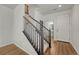 Foyer view featuring staircase, wood flooring, and a glimpse of a bathroom, showcasing the home's interior at 17271 Waterhouse Cir # A, Parker, CO 80134