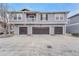 Exterior view of a multi-story townhome featuring three attached garages and second story balcony at 17271 Waterhouse Cir # A, Parker, CO 80134