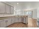 Kitchen with light gray cabinets, stainless steel appliances and hardwood floors, open to the dining room at 17271 Waterhouse Cir # A, Parker, CO 80134
