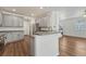 Kitchen with gray cabinets, stainless appliances, peninsula with breakfast bar, and access to living space at 17271 Waterhouse Cir # A, Parker, CO 80134