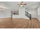 Spacious open-concept living area with wood floors, adjoining the kitchen, and featuring a staircase at 17271 Waterhouse Cir # A, Parker, CO 80134