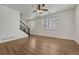 Bright living room with wood floors, staircase, and large windows, creating an inviting space at 17271 Waterhouse Cir # A, Parker, CO 80134