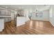 Open living space with hardwood floors, ceiling fan, view to stairs, and connection to kitchen at 17271 Waterhouse Cir # A, Parker, CO 80134