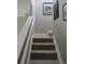 Carpeted staircase with white banister and neutral walls, leading to the upper level of the home at 7456 E 10Th Ave, Denver, CO 80230