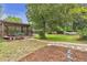 Well-maintained backyard featuring mature trees, a charming gazebo, and a lush green lawn at 3163 S Boston Ct, Denver, CO 80231