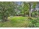 Expansive backyard with lush green lawn, mature trees, lounge chairs, and privacy fence at 3163 S Boston Ct, Denver, CO 80231
