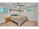 Cozy bedroom with a large bed, decorative plants, and a ceiling fan at 3163 S Boston Ct, Denver, CO 80231