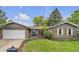 Charming brick home with a well-manicured front yard and an attached two-car garage at 3163 S Boston Ct, Denver, CO 80231