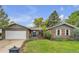 Charming brick home with a well-manicured front yard and an attached two-car garage at 3163 S Boston Ct, Denver, CO 80231