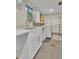 Laundry room featuring white cabinetry, a sink, a counter, a washing machine, and a clothes rack at 3163 S Boston Ct, Denver, CO 80231