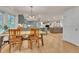 View from dining room to open layout to kitchen and living room, hardwood floors at 3163 S Boston Ct, Denver, CO 80231