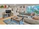 Cozy living room with a comfortable sofa, stylish decor, hardwood floors and lots of natural light at 3163 S Boston Ct, Denver, CO 80231