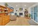 Inviting living room features vaulted ceiling, fireplace, artwork and sliding glass doors at 3163 S Boston Ct, Denver, CO 80231