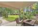 Relaxing covered patio overlooking a lush green backyard, complete with a charming fire pit at 3163 S Boston Ct, Denver, CO 80231