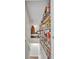 Stairway leading to the basement that is lined with wooden shelves filled with many books at 3163 S Boston Ct, Denver, CO 80231