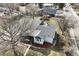 Aerial view of a well-maintained home, mature trees, and a nearby street at 5990 W 8Th Ave, Lakewood, CO 80214