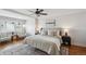 Relaxing bedroom showcases neutral tones, a ceiling fan, and large windows at 5990 W 8Th Ave, Lakewood, CO 80214