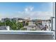 Balcony view from a city dwelling showing Empower Field, multiple mid-rise buildings, and a bright blue sky at 2758 W 22Nd Ave, Denver, CO 80211