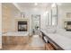 Spa bathroom featuring a fireplace, dual sinks, soaking tub and tiled floors at 2758 W 22Nd Ave, Denver, CO 80211