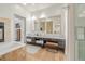 Luxury bathroom with dual sinks, elegant tile work, soaking tub, and a glass shower at 2758 W 22Nd Ave, Denver, CO 80211