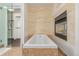 Bright bathroom featuring a soaking tub, and glass shower at 2758 W 22Nd Ave, Denver, CO 80211