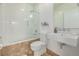 Elegant bathroom with modern fixtures, a glass-enclosed shower, and a sleek vanity, combining style and functionality at 2758 W 22Nd Ave, Denver, CO 80211