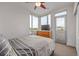 Modern bedroom with floor-to-ceiling windows and access to an outdoor balcony and featuring a ceiling fan at 2758 W 22Nd Ave, Denver, CO 80211