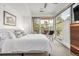 A bright bedroom boasts a large window, a ceiling fan, and views of the outdoors at 2758 W 22Nd Ave, Denver, CO 80211