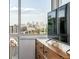 Enjoy cityscape views from this bedroom, featuring a sleek dresser and floor-to-ceiling windows, perfect for urban living at 2758 W 22Nd Ave, Denver, CO 80211