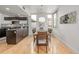 Bright dining room featuring wood floors, a modern light fixture, and views from large windows at 2758 W 22Nd Ave, Denver, CO 80211