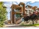 Modern townhome showcasing wood and brick accents, balconies, and professional landscaping at 2758 W 22Nd Ave, Denver, CO 80211
