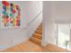 Bright staircase with wood treads, white risers, and a colorful piece of art at 2758 W 22Nd Ave, Denver, CO 80211