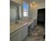 Double vanity bathroom with walk-in closet access at 5127 N Quemoy St, Aurora, CO 80019