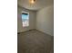 Bright bedroom with neutral carpeting and large window at 5127 N Quemoy St, Aurora, CO 80019