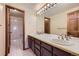 Bathroom with double sinks,dark vanity, and shower/tub combo at 223 Durham Ct, Castle Pines, CO 80108