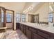 Primary bathroom with double vanity, large mirror, and shower at 223 Durham Ct, Castle Pines, CO 80108