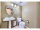 Clean bathroom with pedestal sink, toilet, and tile flooring at 223 Durham Ct, Castle Pines, CO 80108