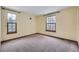 Bright bedroom with carpet flooring and two large windows at 223 Durham Ct, Castle Pines, CO 80108