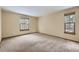 Well-lit bedroom with carpet flooring and two windows at 223 Durham Ct, Castle Pines, CO 80108