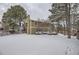 Two-story house exterior with snowy yard at 223 Durham Ct, Castle Pines, CO 80108