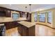 Kitchen with an island, dark wood cabinets and hardwood floors at 223 Durham Ct, Castle Pines, CO 80108