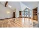 Bright living room with hardwood floors, vaulted ceiling, built-in shelves, and fireplace at 223 Durham Ct, Castle Pines, CO 80108