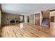 Bright living room with hardwood floors, fireplace, and view of staircase at 223 Durham Ct, Castle Pines, CO 80108