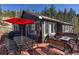 Outdoor seating and dining area on the deck of this mountain home at 10197 Crest View Dr, Morrison, CO 80465