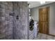 Modern bathroom with a washer and dryer, a tiled shower and neutral colored paint at 10197 Crest View Dr, Morrison, CO 80465
