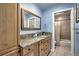 Bathroom with a granite countertop, wood cabinets, tile flooring, and a shower/tub combo at 10197 Crest View Dr, Morrison, CO 80465