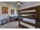Bedroom with a dark wood bunk bed and neutral colored walls and carpet at 10197 Crest View Dr, Morrison, CO 80465